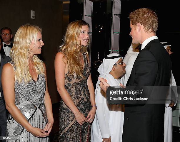 Prince Harry meets singer Joss Stone and presenter Denise Van Outen as he attends a reception ahead of the Sentable 'Forget Me Not' dinner on October...