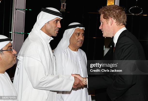 Prince Harry meets guests ahead of the Sentable 'Forget Me Not' dinner on October 7, 2013 in Dubai, United Arab Emirates. The dinner is in...