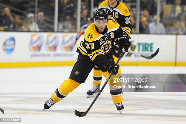 Patrice Bergeron of the Boston Bruins skates with the puck against the Tampa Bay Lightning at the TD Garden on October 3, 2013 in Boston,...