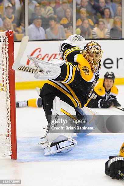 Tuukka Rask of the Boston Bruins tries to make a save against the Tampa Bay Lightning at the TD Garden on October 3, 2013 in Boston, Massachusetts.