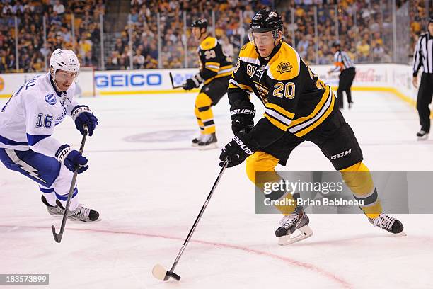 Daniel Paille of the Boston Bruins skates with the puck against Teddy Purcell of the Tampa Bay Lightning at the TD Garden on October 3, 2013 in...