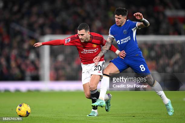Diogo Dalot of Manchester United is challenged by Enzo Fernandez of Chelsea during the Premier League match between Manchester United and Chelsea FC...