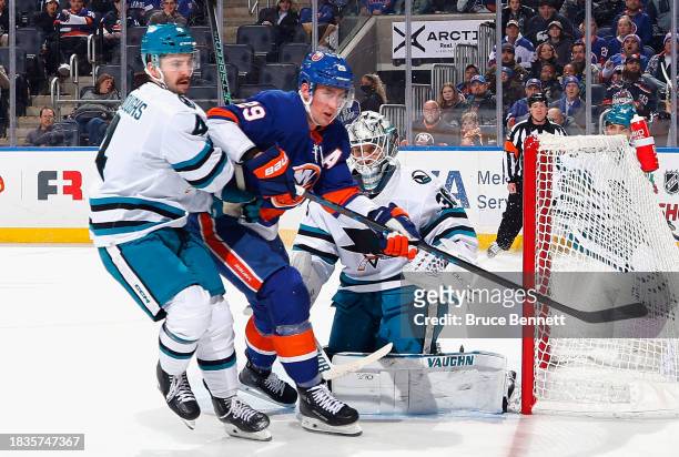 The San Jose Sharks defend against Brock Nelson of the New York Islanders at UBS Arena on December 05, 2023 in Elmont, New York.
