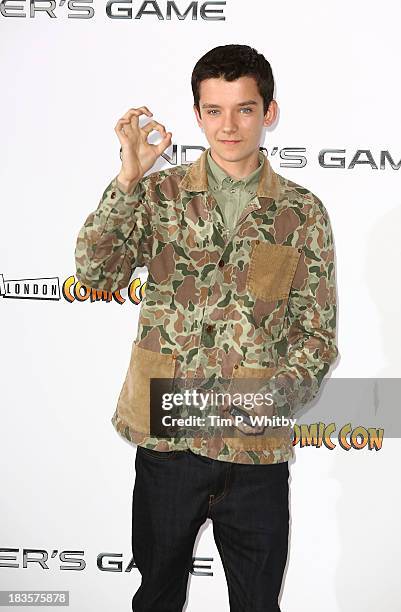 Asa Butterfield attends a photocall to promote "Ender's Game" at Odeon Leicester Square on October 7, 2013 in London, England.