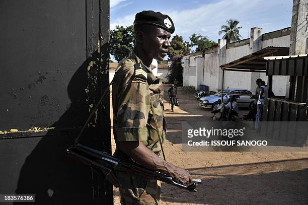 Soldier of the multinational African force stands guard in front of a house on October 7, 2013 in Bangui where weapons and ammunitions were found...
