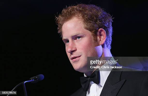 Prince Harry gives a speech at the Sentable 'Forget Me Not' dinner on October 7, 2013 in Dubai, United Arab Emirates. The dinner is in partnership...