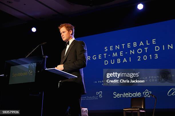 Prince Harry gives a speech at the Sentable 'Forget Me Not' dinner on October 7, 2013 in Dubai, United Arab Emirates. The dinner is in partnership...