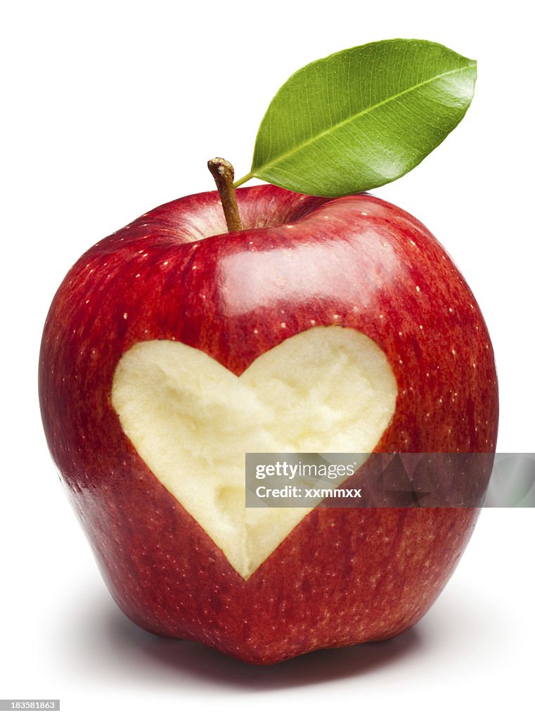 A red apple with a heart inside of it 