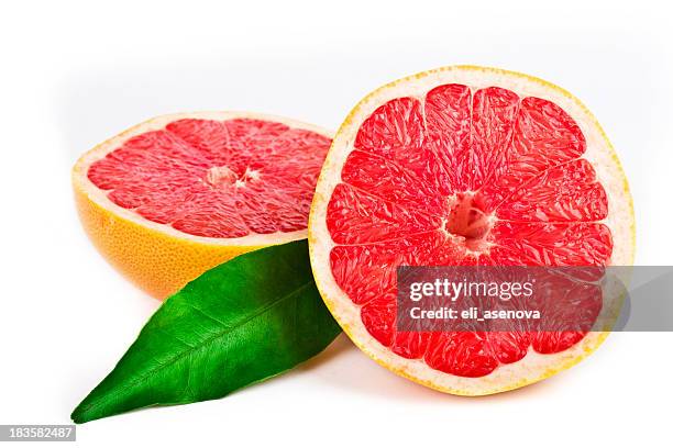 pink grapefruit cut in half with a green leaf - grapefruit stock pictures, royalty-free photos & images