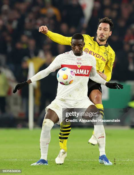 Sehrou Guirassy of VfB Stuttgart is challenged by Mats Hummels of Borussia Dortmund during the DFB cup round of 16 match between VfB Stuttgart and...