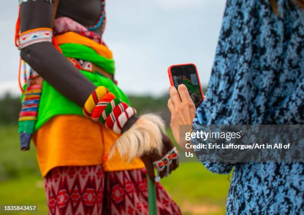 Western tourist taking picture of a samburu morane, Samburu County, Samburu National Reserve, Kenya on November 23, 2023 in Samburu National Reserve,...