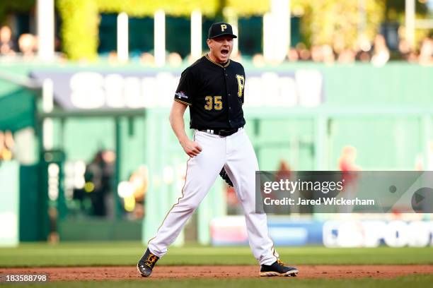 Mark Melancon of the Pittsburgh Pirates celebrates an out in the ninth inning against the St. Louis Cardinals during Game Four of the National League...
