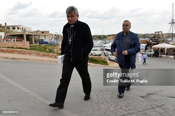 Papal Almoner Archbishop Konrad Krajewski and Bishop of Agrigento Francesco Montenegro arrive at Lampedusa harbour on October 7, 2013 in Lampedusa,...