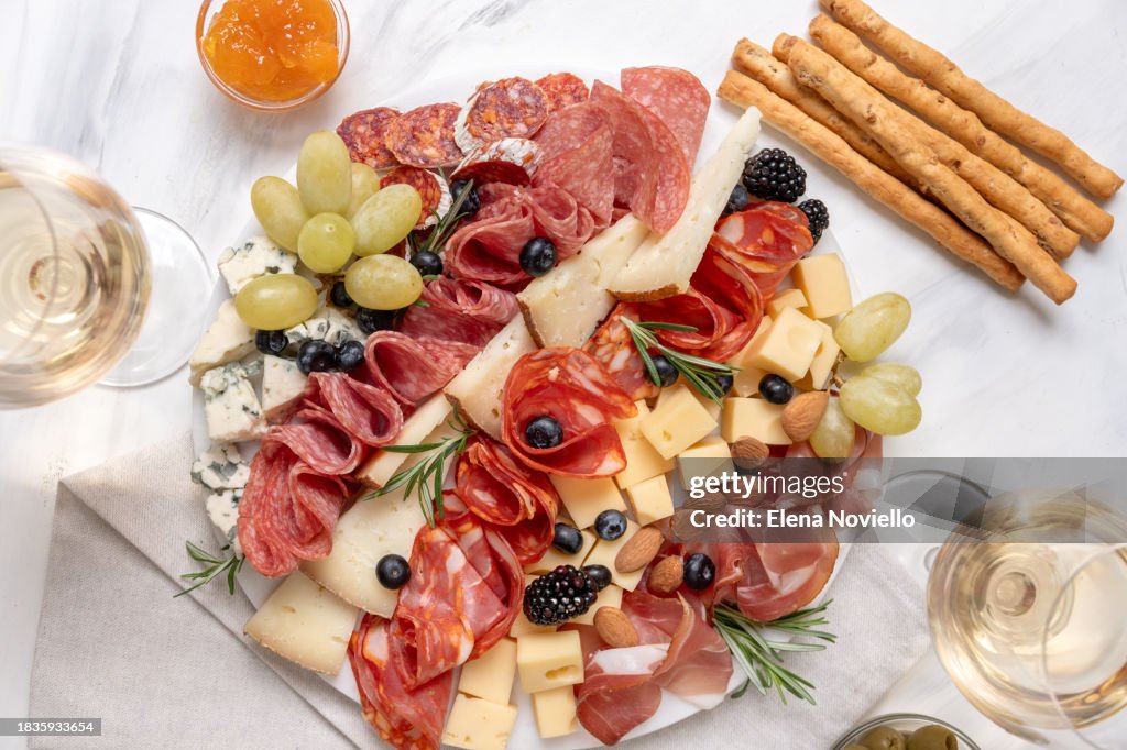 Charcuterie board italian food antipasti prosciutto ham, salami and cheese. festive serving of cold meat appetizers for lunch or dinner for Christmas, New Year, wedding, anniversary, birthday party