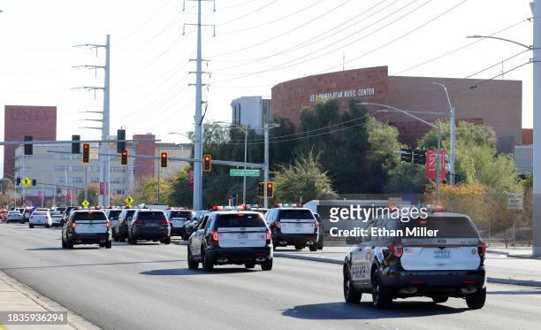 Las Vegas Metropolitan Police Department vehicles head toward the UNLV campus after a shooting on December 06, 2023 in Las Vegas, Nevada. According...