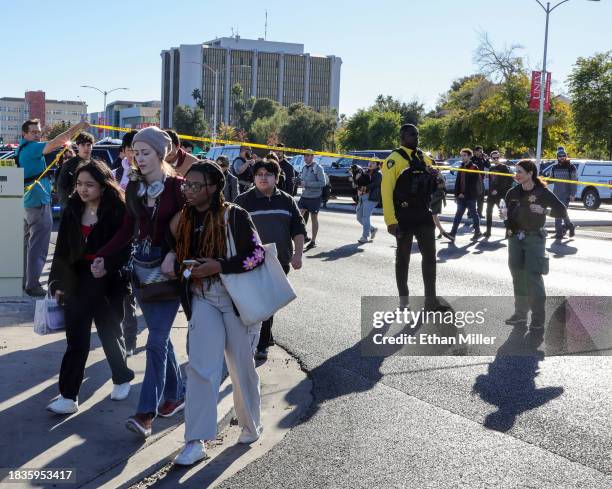 People cross Maryland Parkway as they are led off of the UNLV campus after a shooting on December 06, 2023 in Las Vegas, Nevada. According to Las...