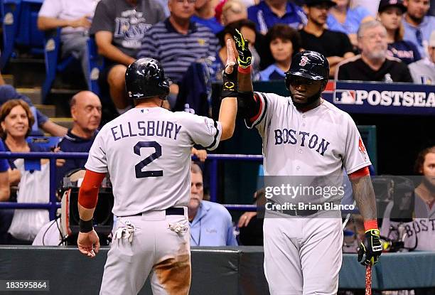 Jacoby Ellsbury and David Ortiz of the Boston Red Sox celebrate after Ellsbury scores off a wild pitch in the fifth inning against the Tampa Bay Rays...