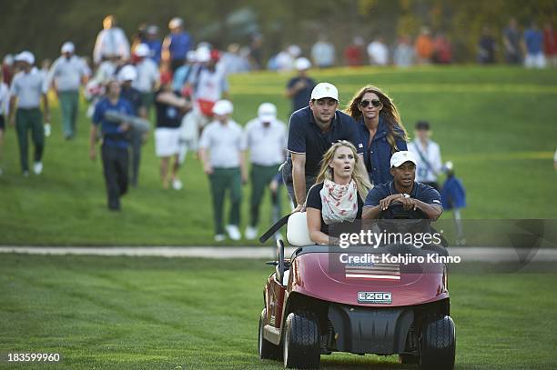 Tiger Woods riding with girlfirend Lindsey Vonn, Keegan Bradley and his girlfriend Jillian Stacey in golf cart during Thursday Fourball Matches at...