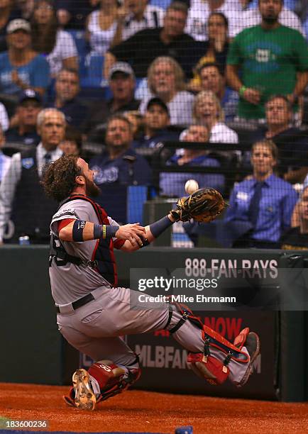 Jarrod Saltalamacchia of the Boston Red Sox catches a foul ball in the eighth inning against the Tampa Bay Rays during Game Three of the American...