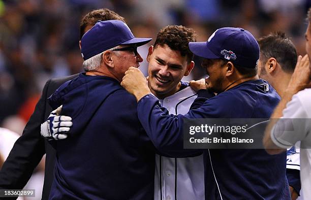 Jose Lobaton of the Tampa Bay Rays is hugged by manager manager Joe Maddon after hitting a walk off home run in the bottom of the ninth inning to...