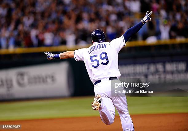 Jose Lobaton of the Tampa Bay Rays rounds the bases after hitting a walk off home run in the bottom of the ninth to defeat the Boston Red Sox during...