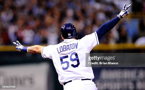 Jose Lobaton of the Tampa Bay Rays rounds the bases after hitting a walk off home run in the bottom of the ninth to defeat the Boston Red Sox during...