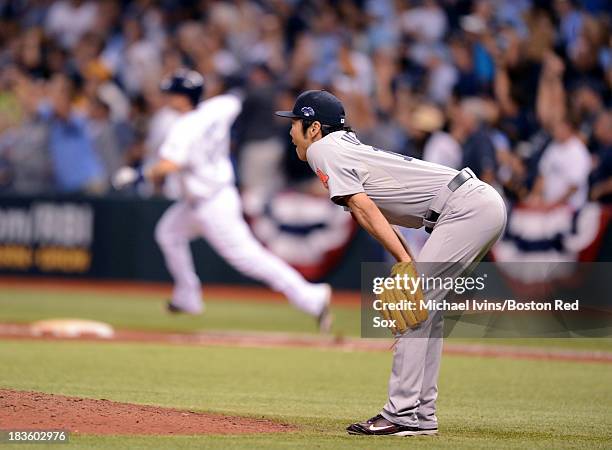 Koji Uehara of the Boston Red Sox reacts after allowing a game winning home run to Jose Lobaton of the Tampa Bay Rays during the ninth inning of Game...