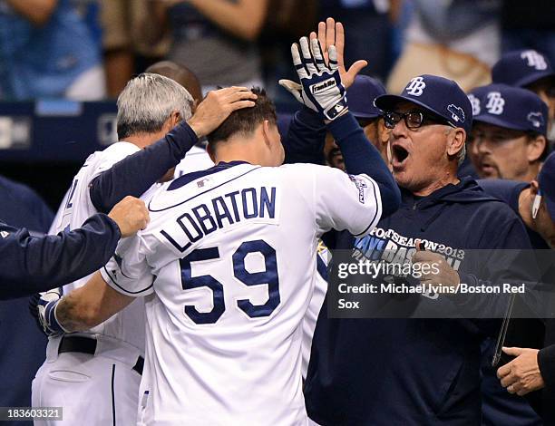 Manager Joe Maddon of the Tampa Bay Rays congratulates Jose Lobaton after he hit a game-winning home run against Koji Uehara of the Boston Red Sox in...