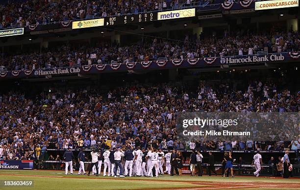 The Tampa Bay Rays celebrate after a walk off home run by Jose Lobaton in the bottom of the ninth inning to defeat the Boston Red Sox during Game...