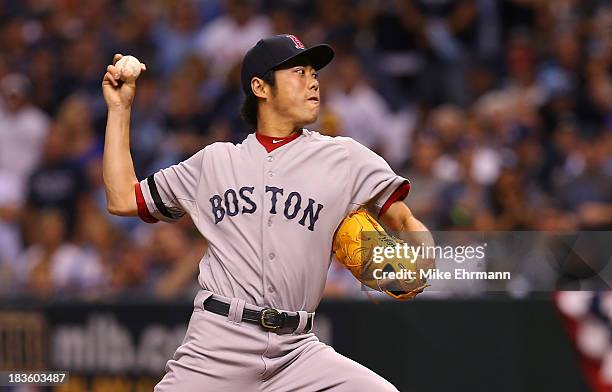 Koji Uehara of the Boston Red Sox pitches in the bottom of the ninth against the Tampa Bay Rays during Game Three of the American League Division...