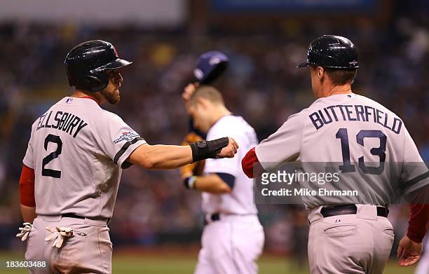 Jacoby Ellsbury of the Boston Red Sox celebrates with third base coach Brian Butterfield after stealing third base in the ninth inning against the...
