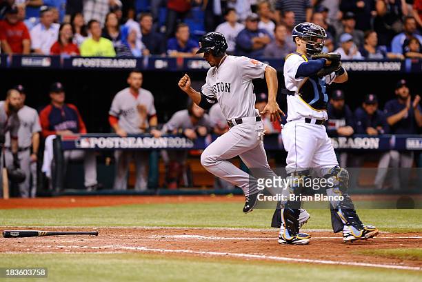 Xander Bogaerts of the Boston Red Sox scores on a grounder by Jacoby Ellsbury in the ninth inning against the Tampa Bay Rays during Game Three of the...