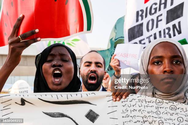Activists chant as they march in major climate crisis protest in the conference venue, Blue Zone during the COP28, UN Climate Change Conference, held...
