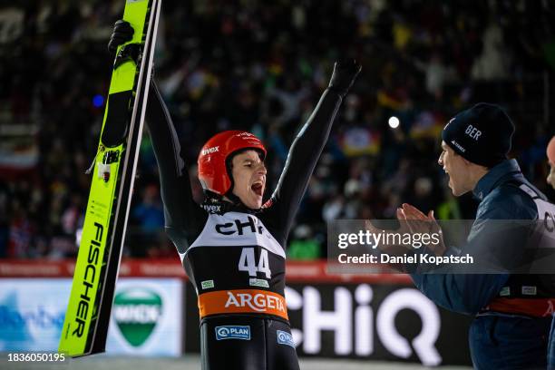 Karl Geiger of Germany celebrates with teammates Andreas Wellinger of Germany and Pius Paschke of Germany during the final round for the FIS World...