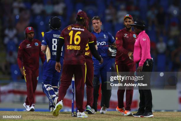 Players shake hands after England win the 2nd CG United One Day International match between West Indies and England at Sir Vivian Richards Stadium on...