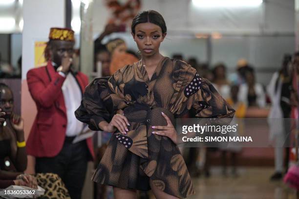 Model presents a creation by Kenyan designer Morgan Azedy during the main fashion show of the Africa Fashion Week, at the delight technical college...