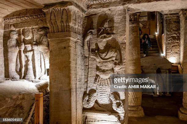 Relief of the ancient Egyptian funerary deity Anubis and others are pictured as a visitor descends a staircase at the ancient catacomb necropolis of...