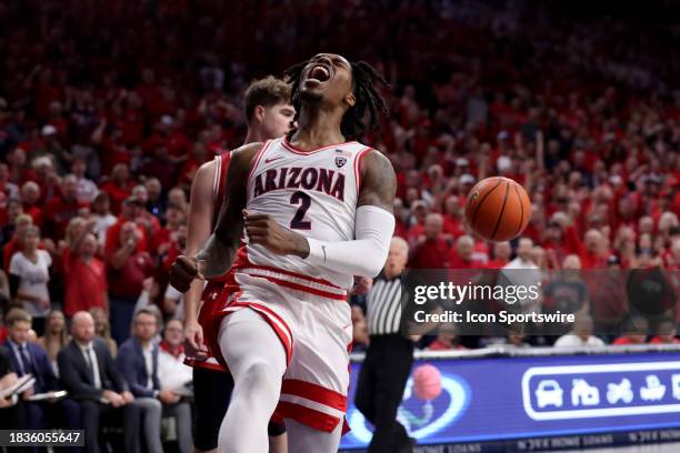 Arizona Wildcats guard Caleb Love celebrates a dunk during the first half of a men's basketball game between the Wisconsin Badgers and the University...