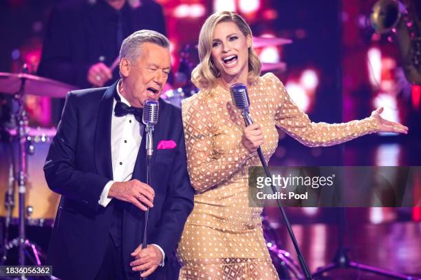 Roland Kaiser and Michelle Hunziker perform on stage during the Ein Herz fuer Kinder charity gala at Studio Berlin Adlershof on December 09, 2023 in...