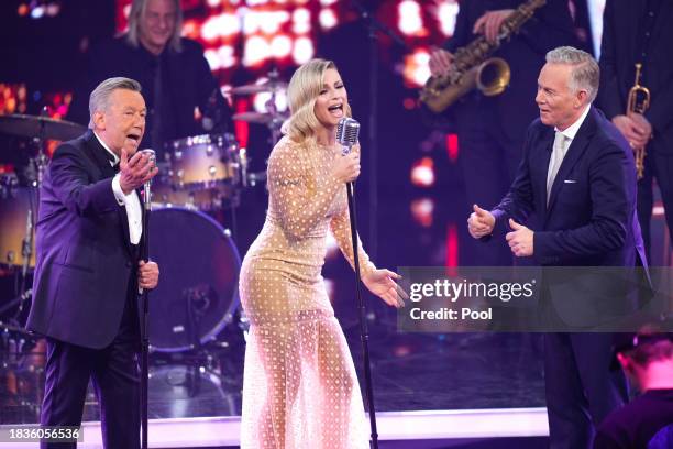 Roland Kaiser, Michelle Hunziker and Johannes B Kerner perform on stage during the Ein Herz fuer Kinder charity gala at Studio Berlin Adlershof on...