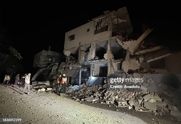 Residents and civil defense teams conduct a search and rescue operation among demolished building after Israeli attacks hit the apartment belonging...