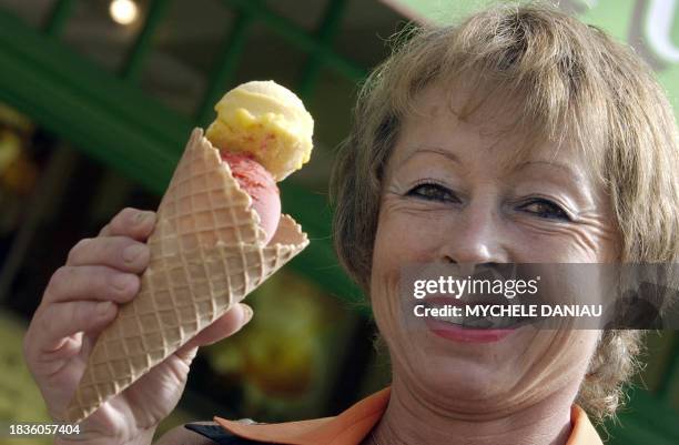 Ice cream maker Martine Lambert shows her homemade ice cream 12 July 2006 in front of her store in the northwestern French resort of Deauville. She...