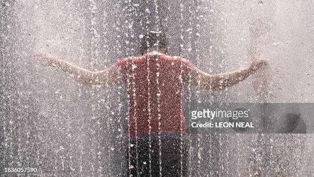 Boy plays in the fountains near the South Bank centre in central London, on August 19, 2009. Temperatures in London were expected to reach 84F on...