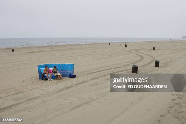 Dutch family, the Kettings from The Hague, take position in the early morning on the beach of Scheveningen, in the Netherlands, July 1, 2009. Though...