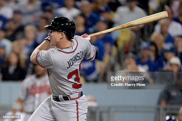 Elliot Johnson of the Atlanta Braves hits a triple in the seventh inning against the Los Angeles Dodgers in Game Four of the National League Division...