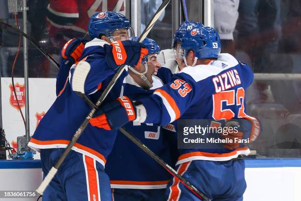 Jean-Gabriel Pageau of the New York Islanders is congratulated by Casey Cizikas, Simon Holmstrom and Noah Dobson after scoring the game-winning goal...