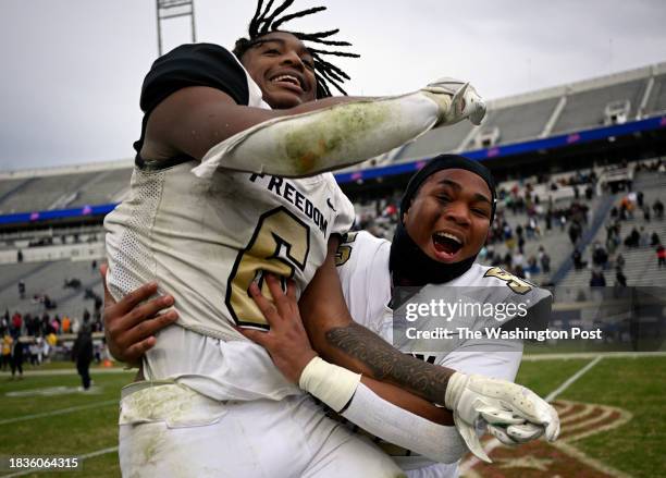 Freedom's Jeff Overton, left, is hoisted by teammate DeMontre Adams in celebration after the Freedom Eagles' defeat of the Highland Springs Springers...