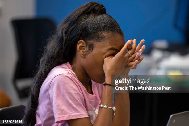 Kanihya Glover rubs her eyes during a weekly group meeting for students impacted by gun violence at Duke Ellington School of the Arts in Washington,...