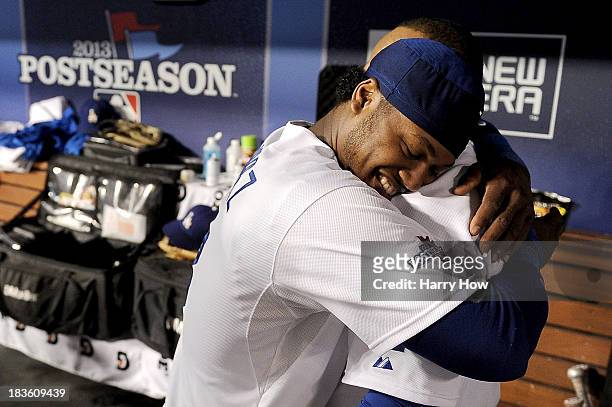 Hanley Ramirez hugs Juan Uribe of the Los Angeles Dodgers after Uribe hits a two-run home run in the eighth inning against the Atlanta Braves in Game...