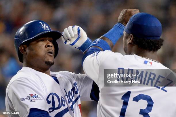 Juan Uribe of the Los Angeles Dodgers celebrates with Hanley Ramirez after Uribe hits a two-run home run in the eighth inning against the Atlanta...